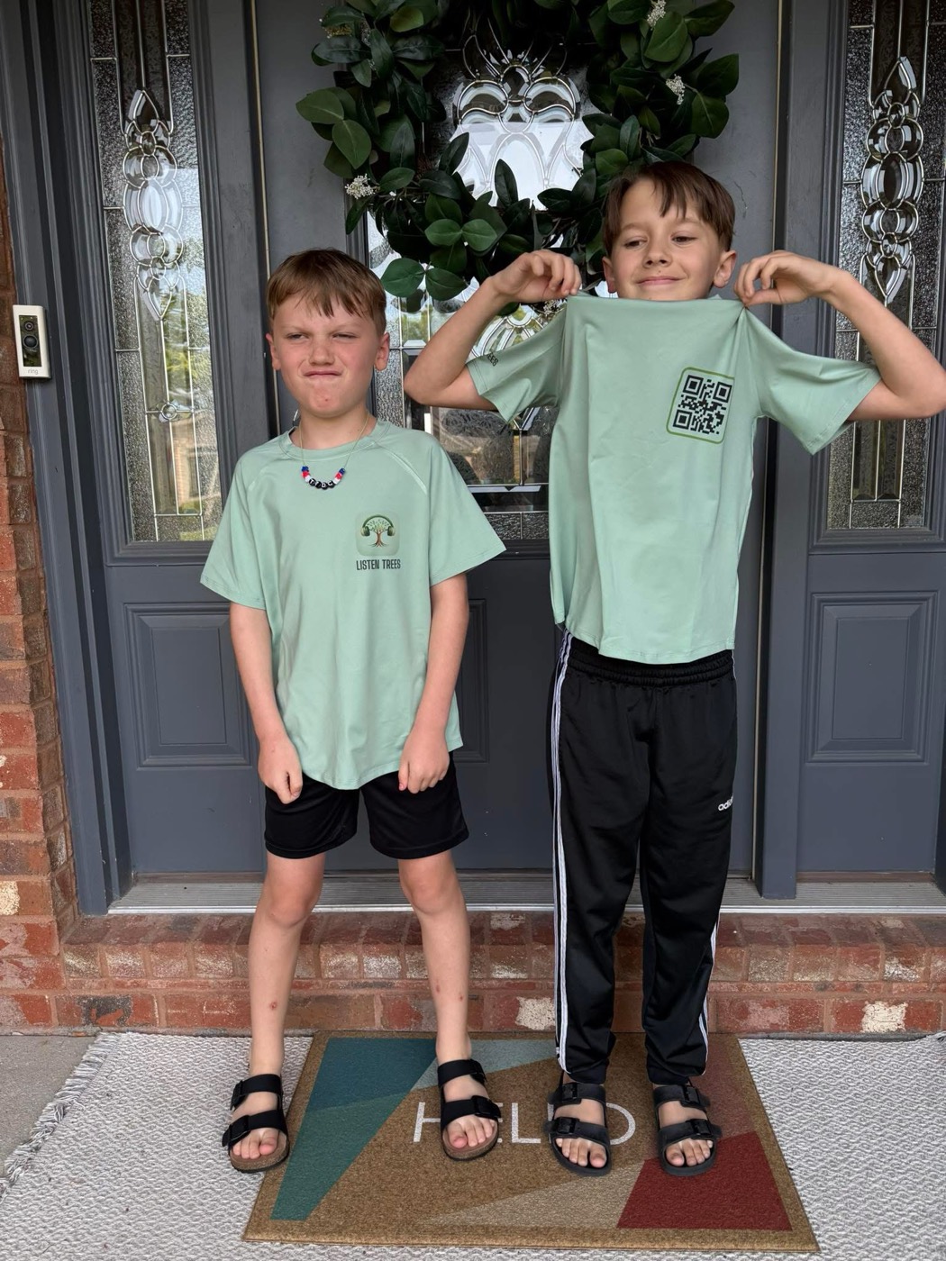 The two boys wearing Listen Trees t-shirts
