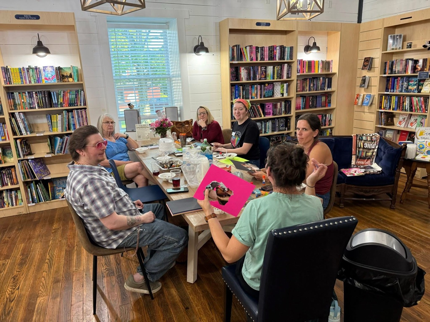 The audiobook club gathered around a table at the bookstore