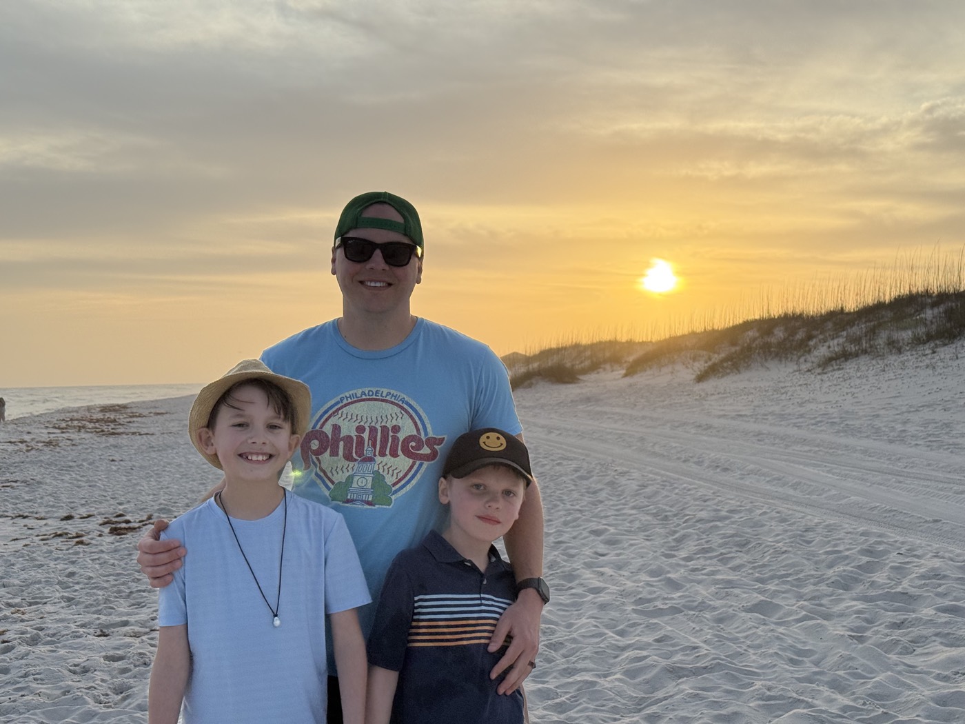 Dad and the two boys on the beach at sunset